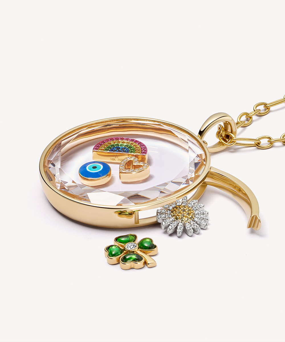 Sapphire rainbow gold charm styled on top of a pink fruit paste square