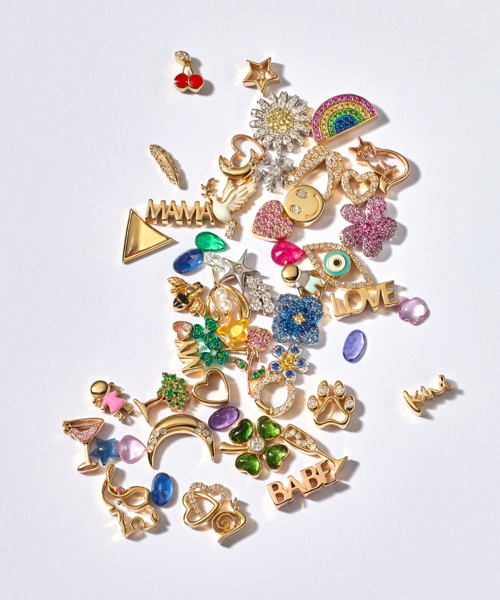 Sapphire rainbow gold charm styled on top of a pink fruit paste square