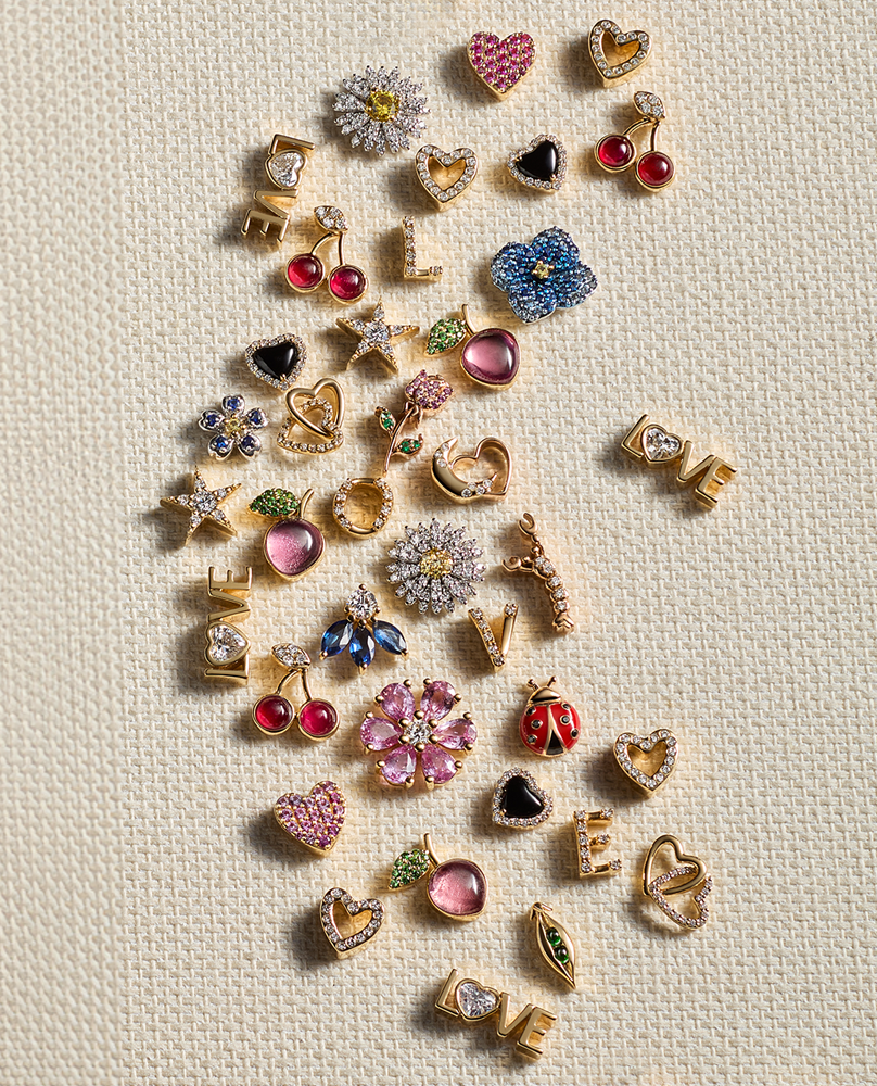 Sapphire rainbow gold charm styled on top of a pink fruit paste square