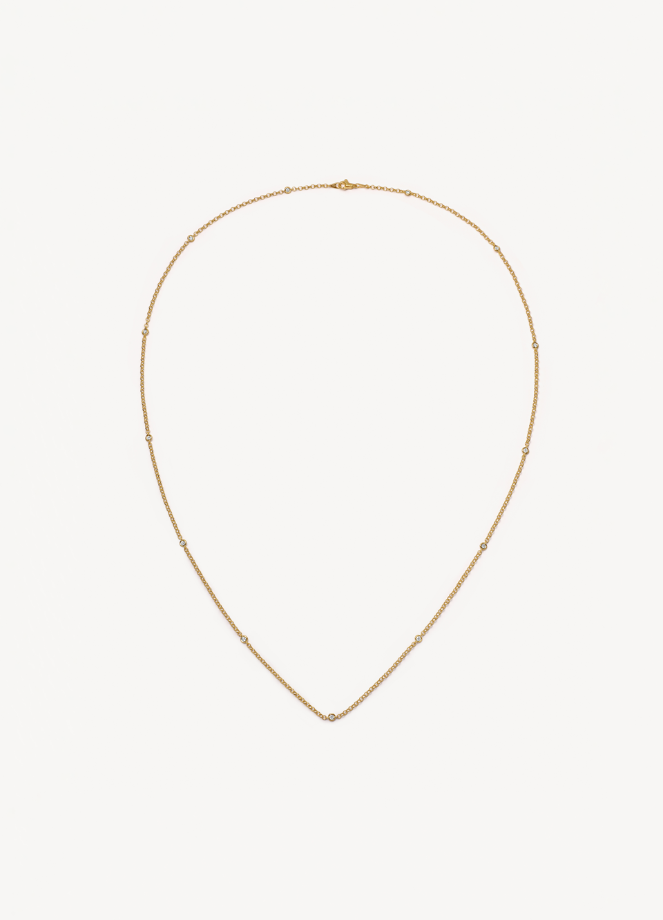 yellow gold rolo link chain with diamond details.