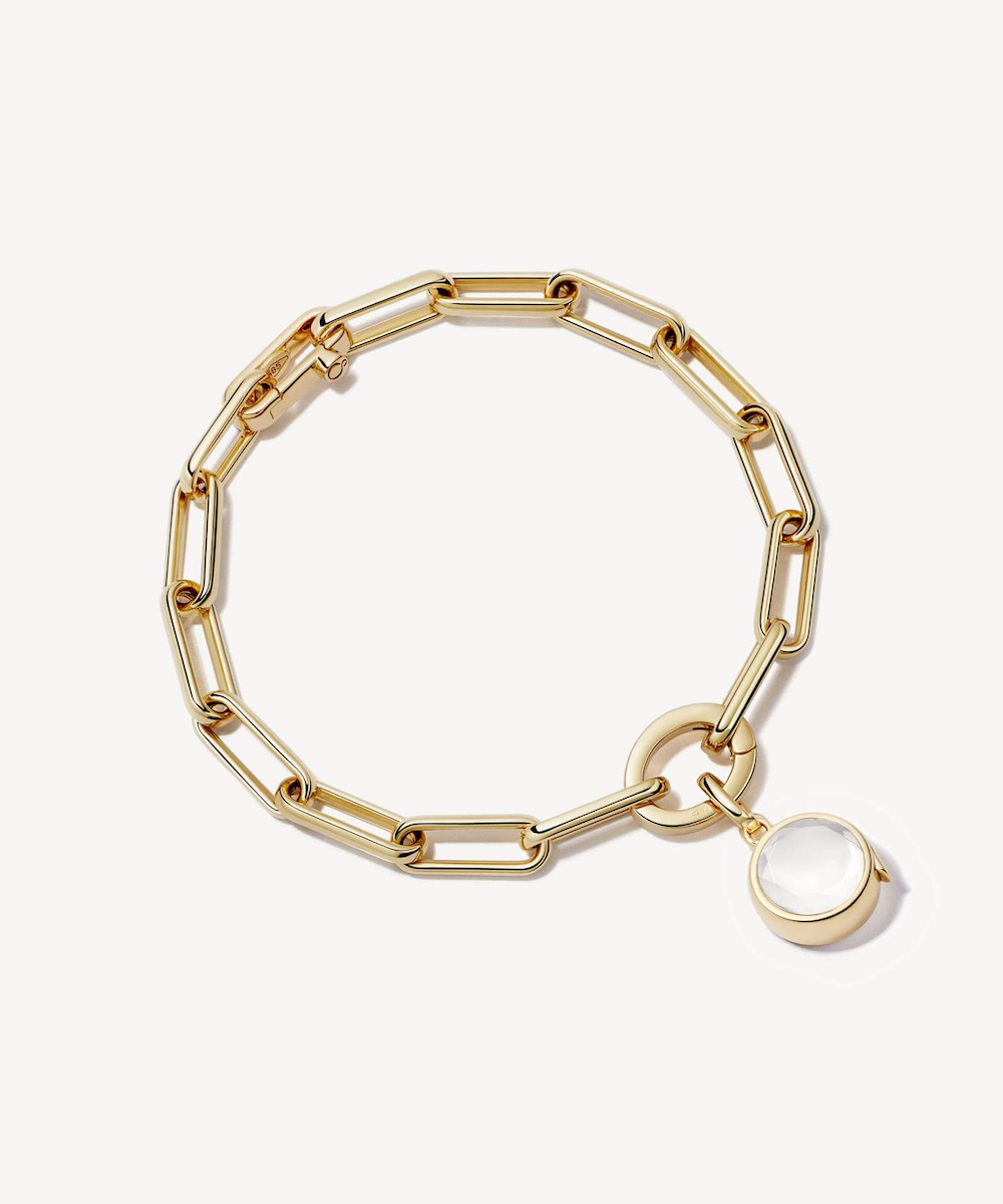 Gold link bracelet with midi heart shaped locket attached with charms.