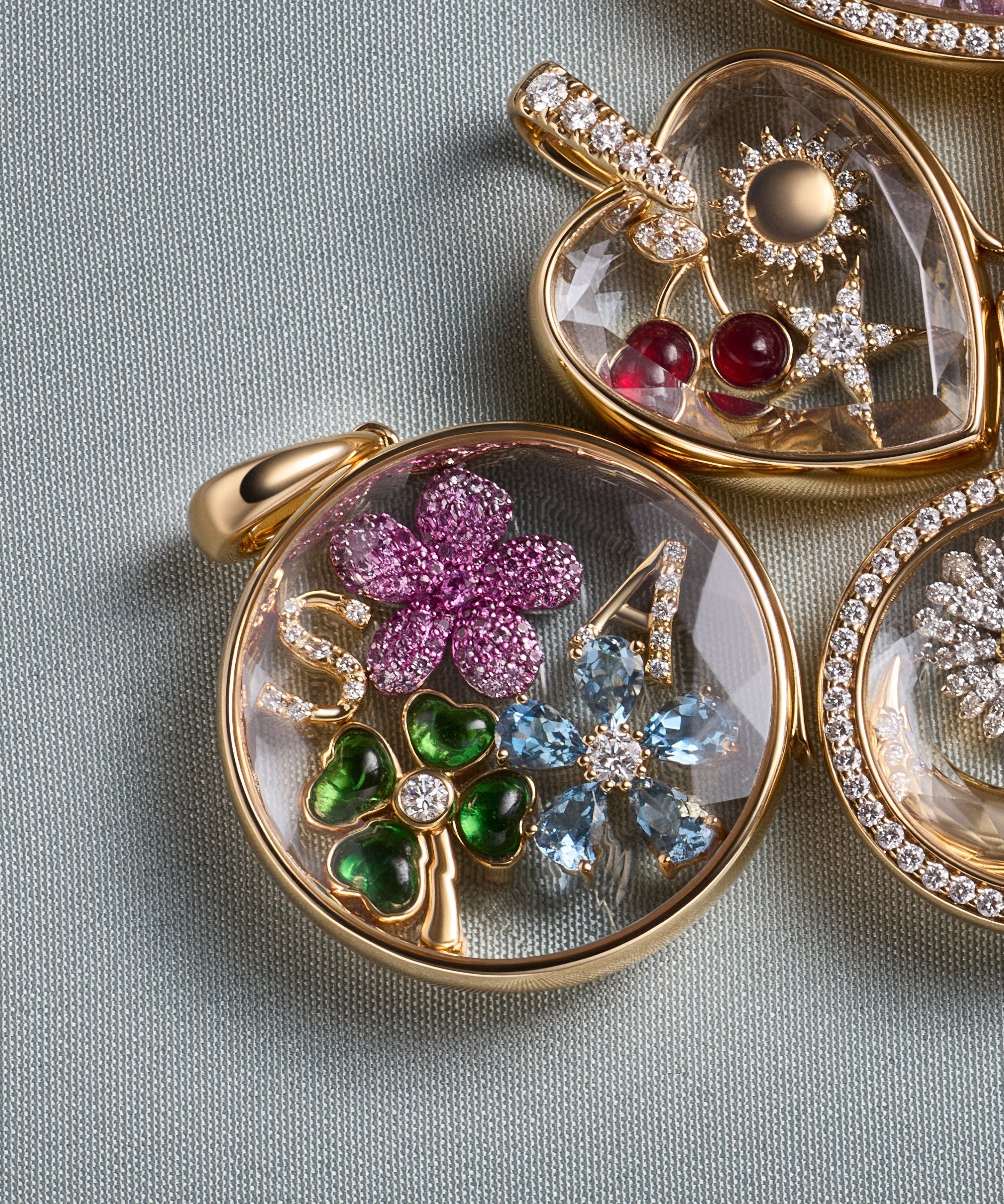 Diamond rim round locket pendant in yellow gold and diamond bail with faceted crystal facade.