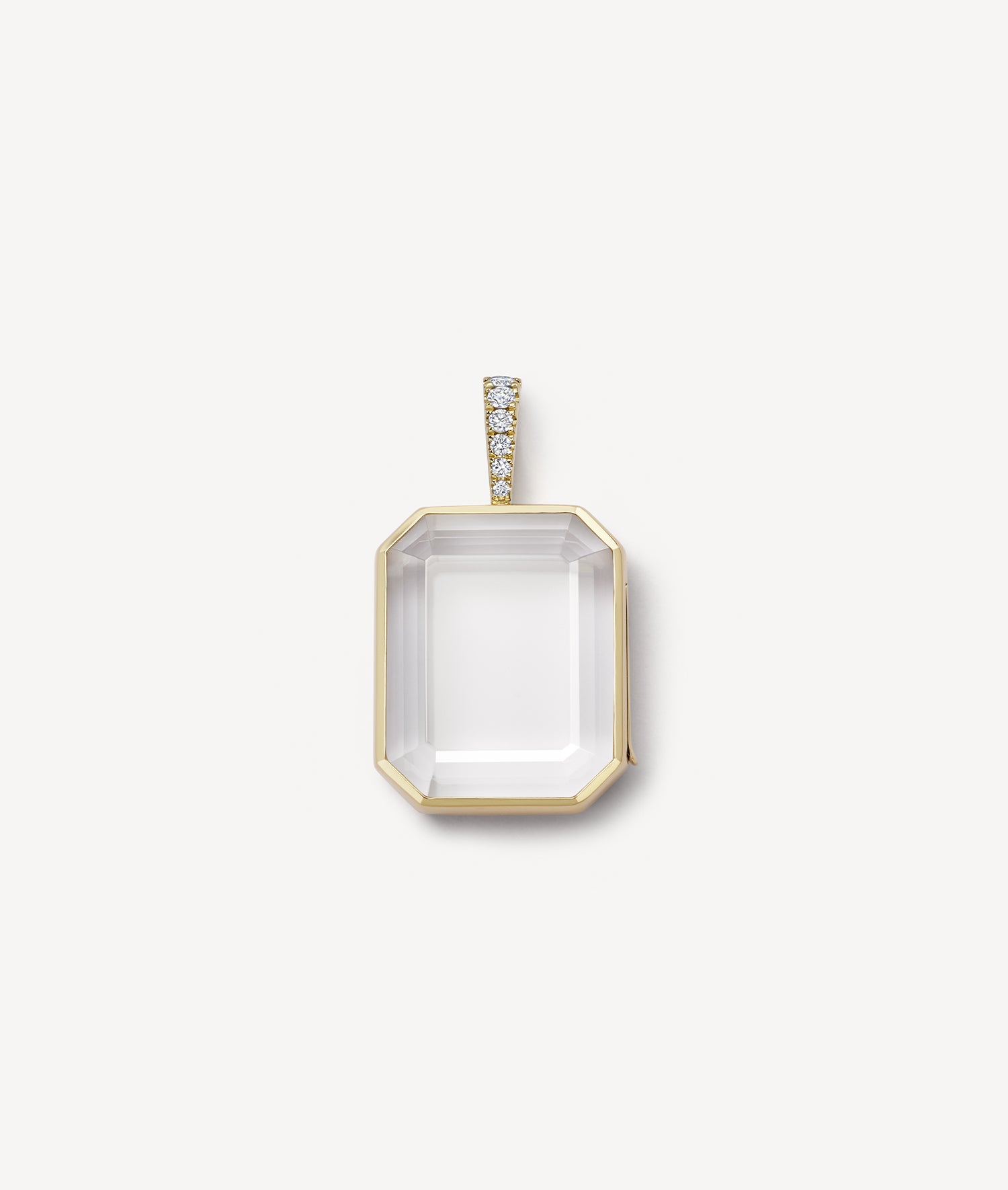 Gold baguette locket with diamond bail and crystal facade on a white background