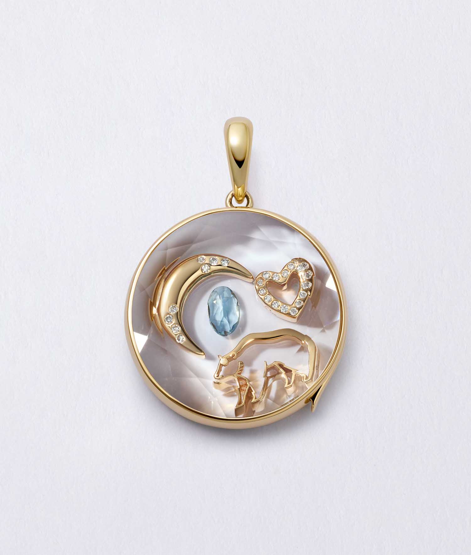 18k yellow gold bear spirit animal charm featured with a heart, moon, and gemstone charms in a locket design.
