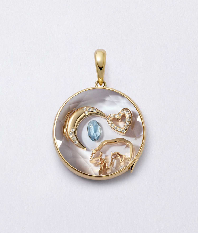18k yellow gold bear spirit animal charm featured with a heart, moon, and gemstone charms in a locket design.