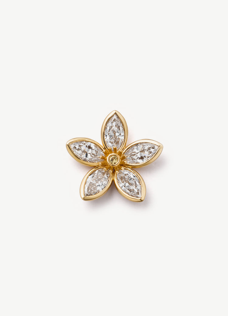 A gold flower-shaped charm with six marquise-cut diamond, photographed on a clean, light off-white background.