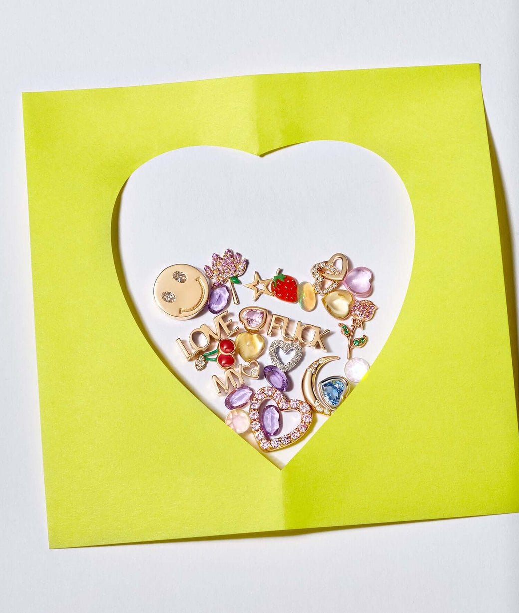 charm scatter inside a yellow heart cut out.