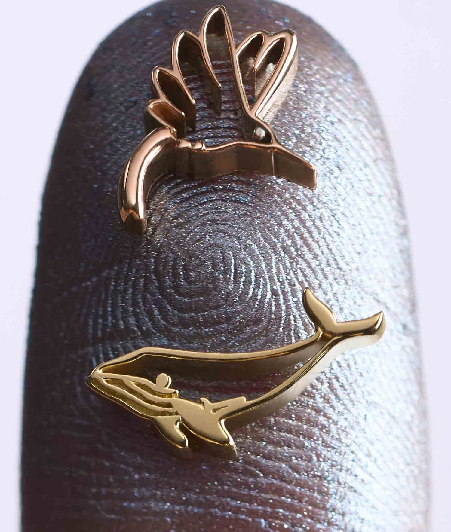 Whale Spirit Animal Charm in 18k yellow gold, featuring a whale and hummingbird charm design on fingertip.