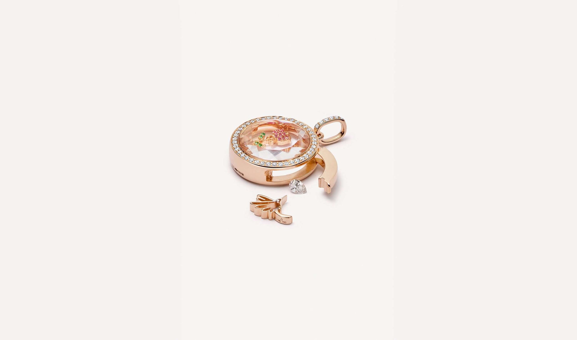 April birthstone, a diamond styled outside the open latch of a helios round diamond rose gold locket.