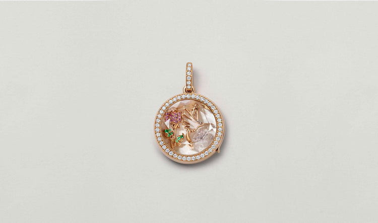 April birthstone, a diamond styled in a helios round diamond, rose gold locket with rose charm and hummingbird charm.