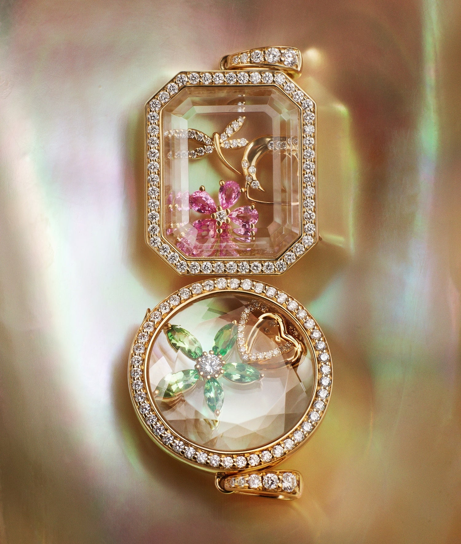 Heritage Baguette and Round Locket pendants styled with charms on a nacre shell background