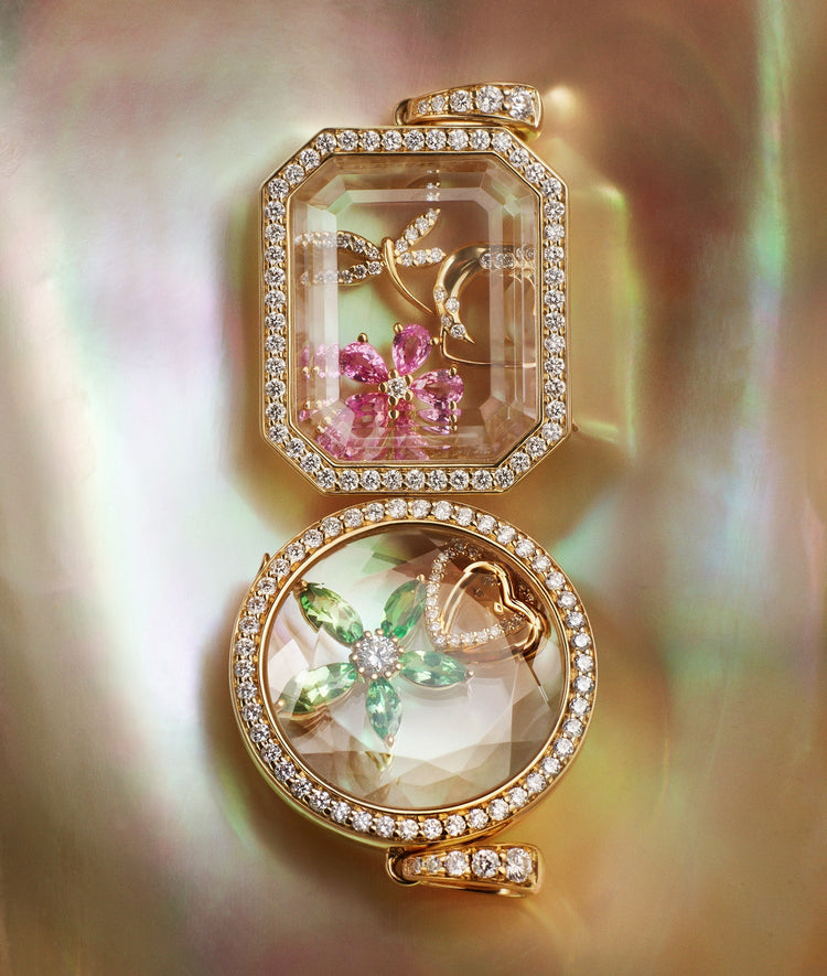Heritage Baguette and Round Locket pendants styled with charms on a nacre shell background