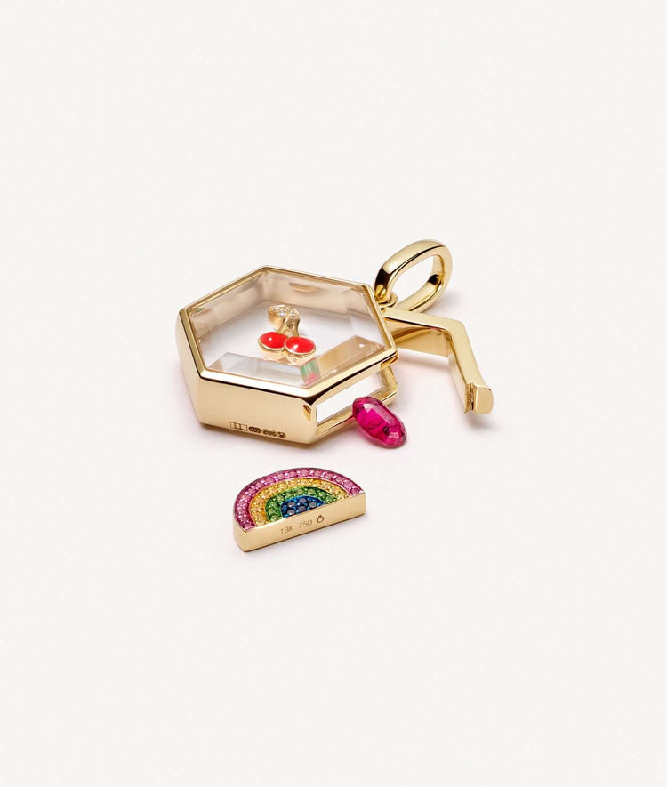 Yellow gold honeycomb locket styled open with charms.