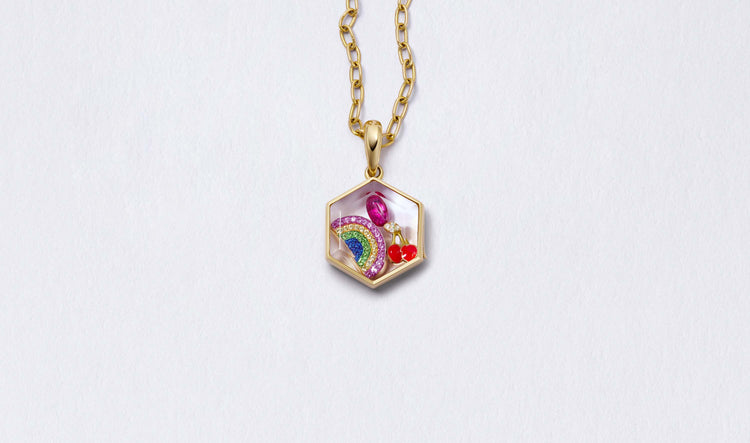 Honeycomb Gold Locket 14k personalised with colourful solid 18k gold charms and hanging on a yellow gold chain photographed on a neutral background.