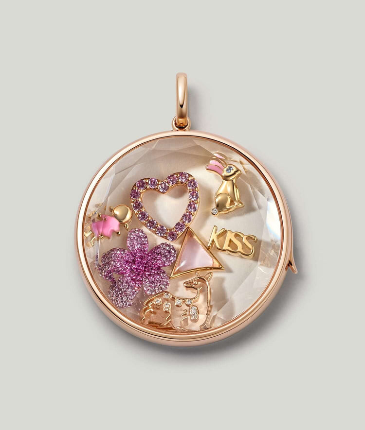 18k gold deer spirit animal charm with diamonds styled in our large locket with other charms.