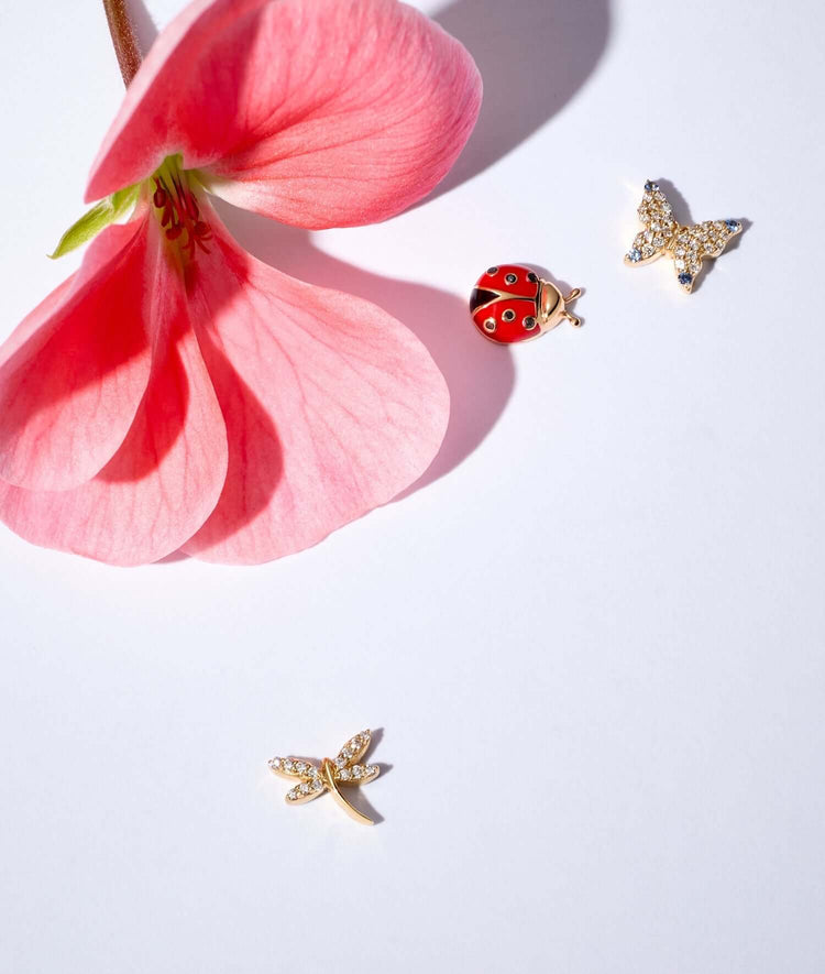 Diamond Butterfly charm, Ladybird charm, diamond dragonfly charm styled with a pink flower.