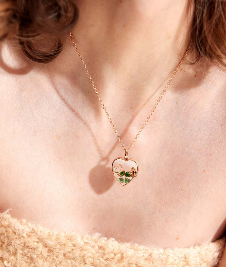 Rolo rose gold necklace 16-18 inch attached to a rose gold heart with charms.