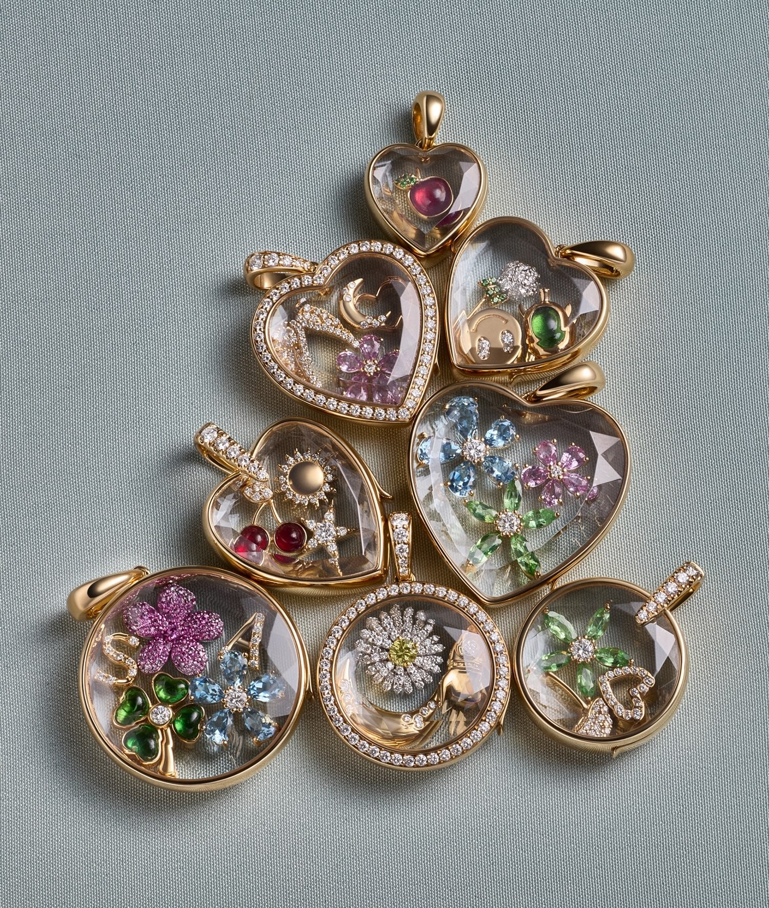 Heart and Round locket pendants in yellow gold with crystal facade styled with charms with different shapes and diamonds and gemstones