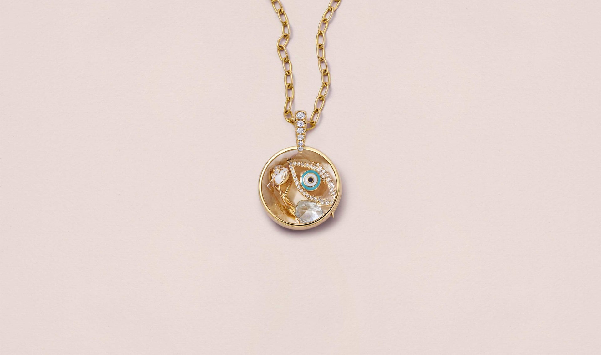 Lyra Round Diamond Gold Locket 14k  personalised with colourful solid 18k gold charms and hanging on a yellow gold chain photographed on a neutral background.