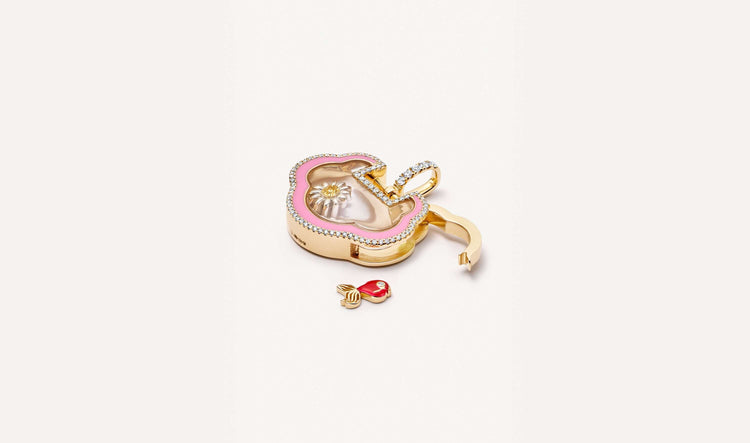 Nimbus diamond cloud pillow, gold locket styled open with a goldfish charm.