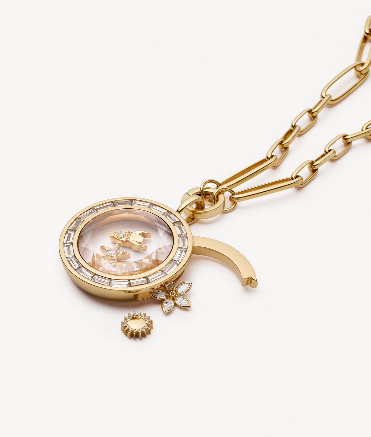 Gold locket pendant necklace with crystal facade styled with open latch with gold and diamond charms on a white background