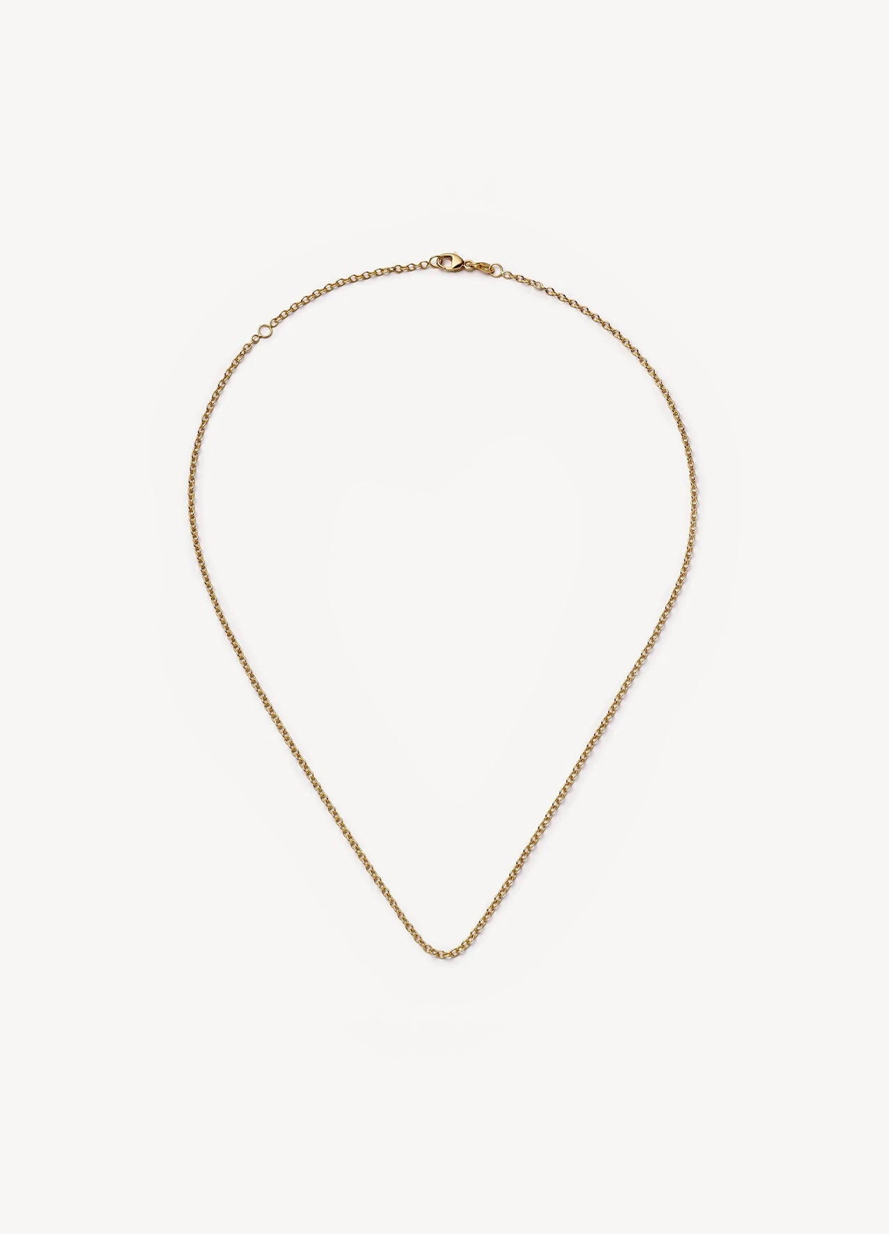 A delicate gold chain necklace with a lobster clasp, displayed in a teardrop shape against a clean, off-white background.