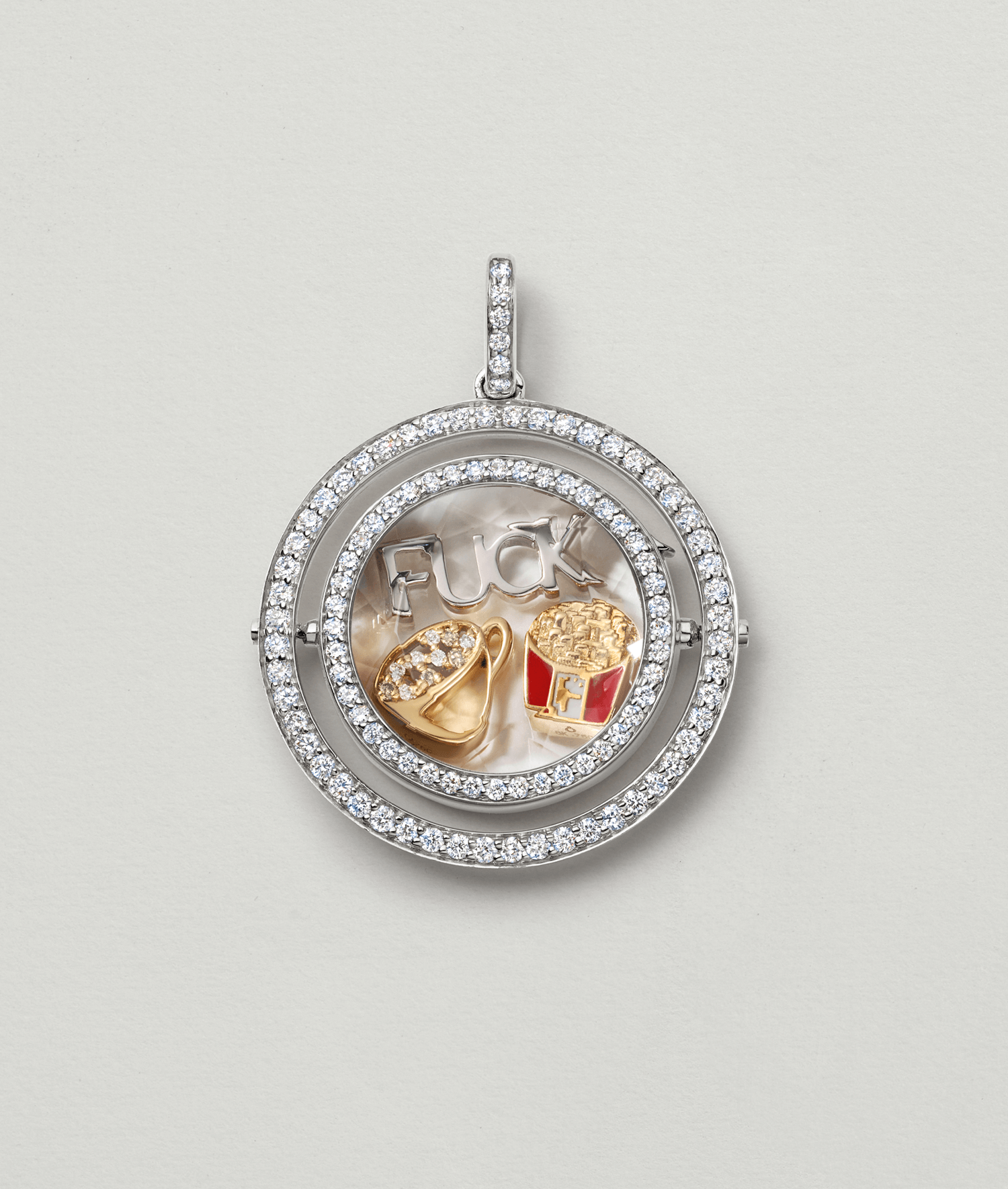 Saturn diamond locket in white gold personalised with a coffee cup charm and other charms of our collection