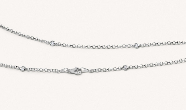 Close up shot of the white gold diamond necklace, short chain.