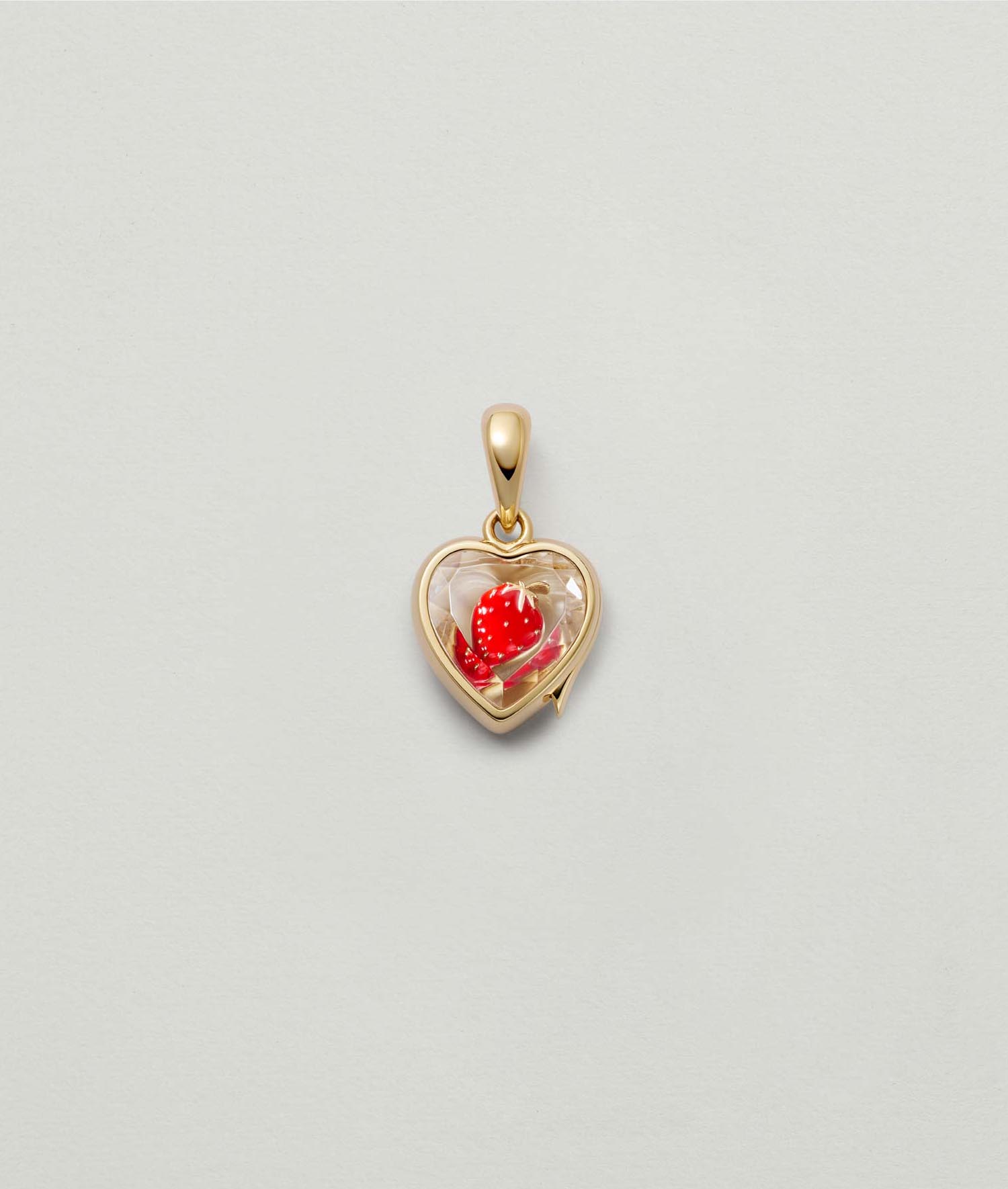 yellow gold heart-shaped locket pendant with a red strawberry charm inside on a light background.